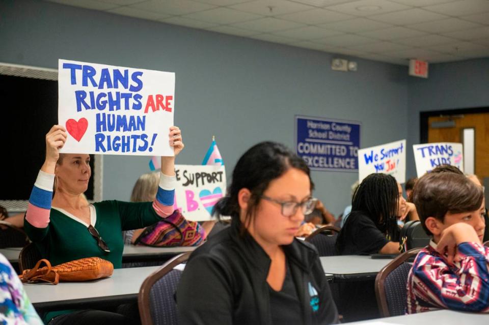 Mississippi Rising Coalition President Lea Campbell and other members of the Mississippi Rising Coalition hold posters in support of L.B., a transgender student who didn’t walk in her graduation because of the dress code, and other students who were unable to walk to due the school’s dress code during a Harrison County School Board meeting at the Central Office in Gulfport on Monday, June 5, 2023.