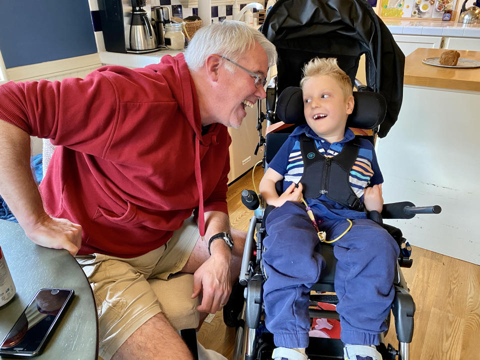 Jack with his grandfather, pre-pandemic. Jack was just learning to use a computer to communicate when the COVID-19 lockdowns started. Now his mother worries he may never gain that ability. (Courtesy Stuart family)