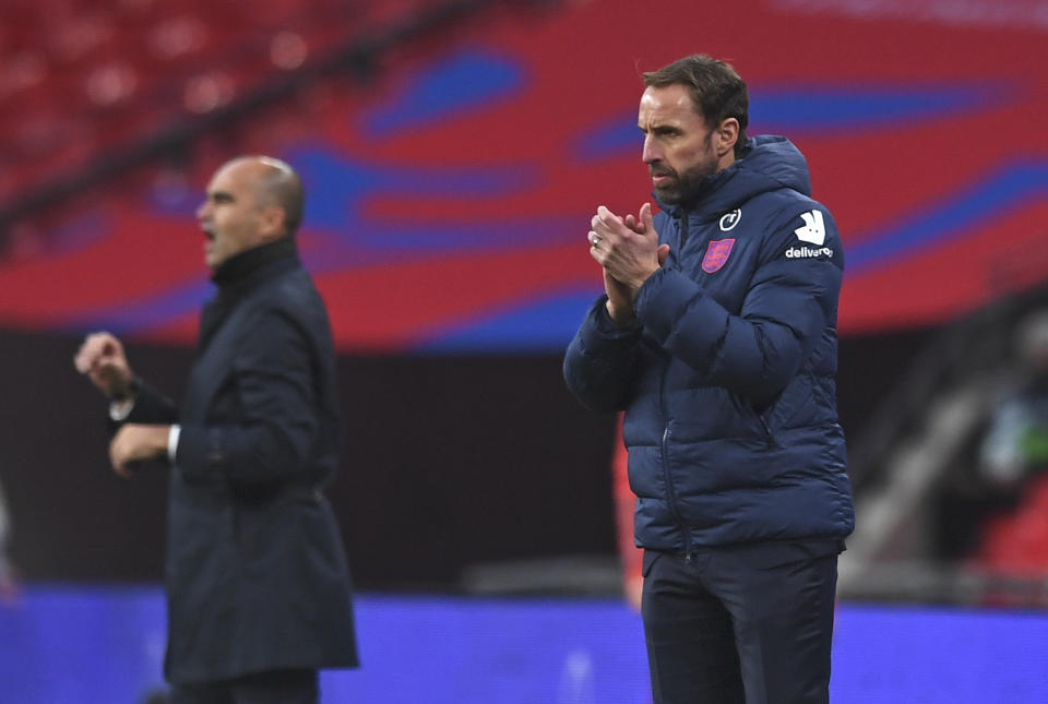 Belgium's coach Roberto Martinez, left, and England's coach Gareth Southgate stand on the touchline during the UEFA Nations League soccer match between England and Belgium at Wembley stadium in London, Sunday, Oct. 11, 2020. (Neil Hall/Pool via AP)