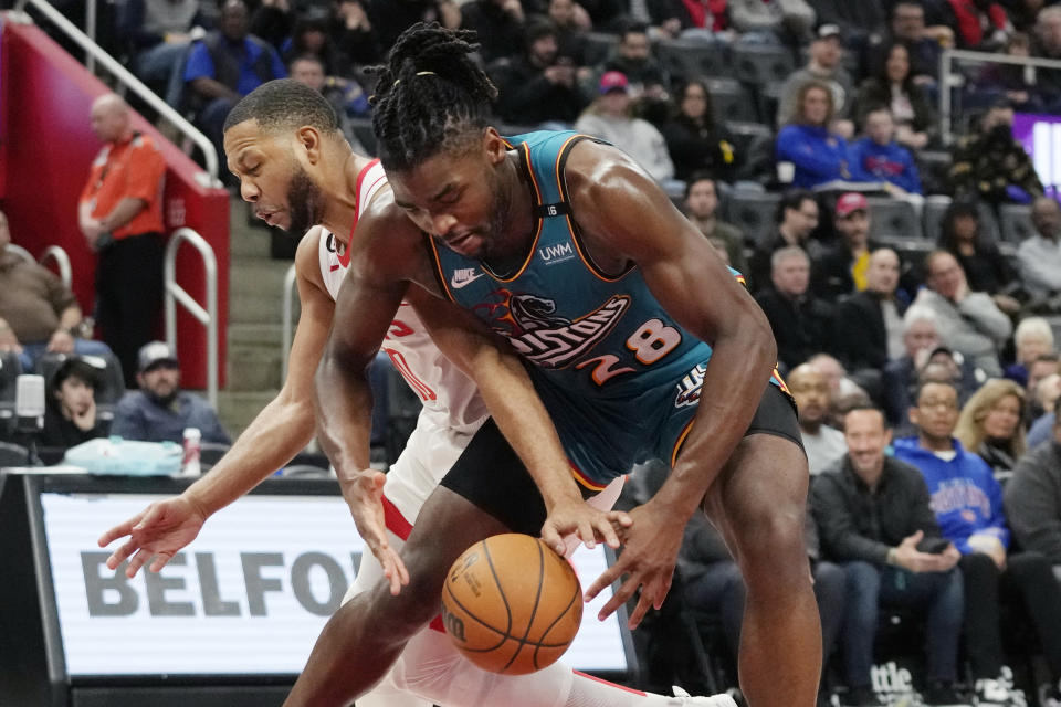 Houston Rockets guard Eric Gordon and Detroit Pistons center Isaiah Stewart (28) reach for the loose ball during the first half of an NBA basketball game, Saturday, Jan. 28, 2023, in Detroit. (AP Photo/Carlos Osorio)