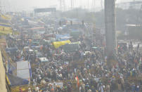 NEW DELHI, INDIA - JANUARY 26: Demonstrators heading into the capital during a tractor rally on Republic Day, at Ghazipur on January 26, 2021 in New Delhi, India. Major scenes of chaos and mayhem at Delhi borders as groups of farmers allegedly broke barricades and police check posts and entered the national capital before permitted timings. Police used tear gas at Delhi's Mukarba Chowk to bring the groups under control. Clashes were also reported at ITO, Akshardham. Several rounds of talks between the government and protesting farmers have failed to resolve the impasse over the three farm laws. The kisan bodies, which have been protesting in the national capital for almost two months, demanding the repeal of three contentious farm laws have remained firm on their decision to hold a tractor rally on the occasion of Republic Day. (Photo by Sakib Ali/Hindustan Times via Getty Images)