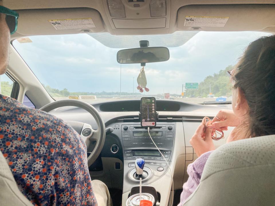 Two people in a car viewed from the backseat