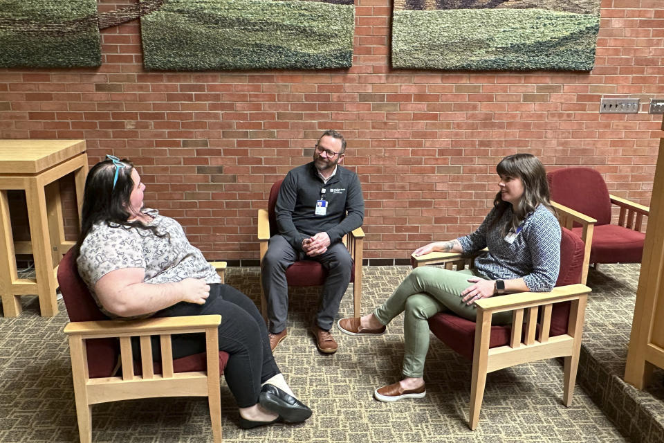 Eric Johnson, center, director of spiritual care at UnityPoint Health's Des Moines, Iowa-area hospitals, talks with other chaplains serving under his direction, on March 11, 2024. Chaplains, traditionally a clergyperson ministering outside of a congregation, have long served in the U.S., but some conservatives are hoping to introduce the role in public schools. (AP Photo/Hannah Fingerhut)