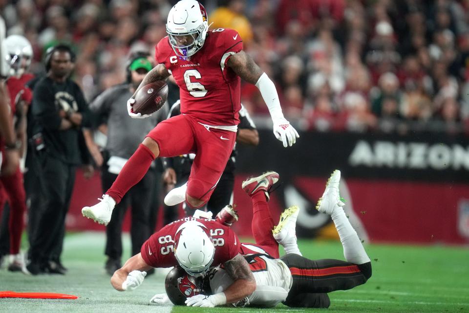 Dec 25, 2022; Glendale, Arizona, USA; Arizona Cardinals running back James Conner (6) leaps forward for extra yards against the Tampa Bay Buccaneers at State Farm Stadium.