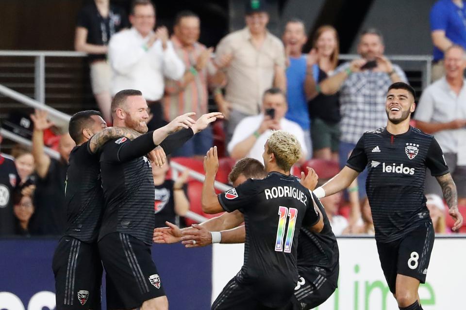 D.C. United forward Wayne Rooney (9) celebrates with teammates after scoring a goal from beyond midfield against Orlando City SC in the first half at Audi Field.