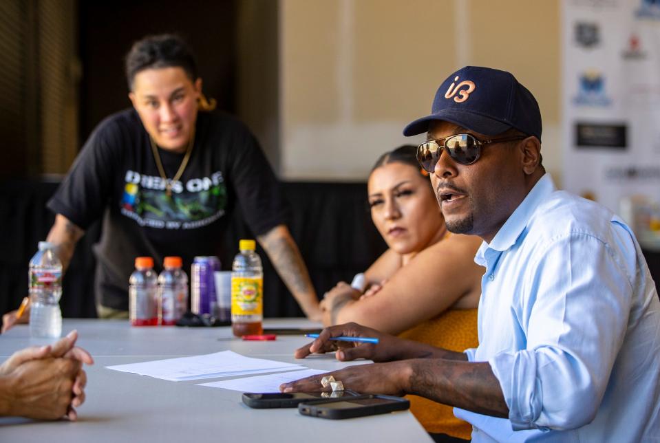 Music Changing Lives founder Josiah Bruny talks to members of his team to debrief at the end of an event at Music Changing Lives in Thousand Palms, Calif., Saturday, Oct. 1, 2022. 