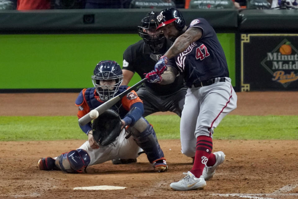 FILE - In this Oct. 30, 2019, file photo, Washington Nationals' Howie Kendrick hits a two-run home run against the Houston Astros during the seventh inning of Game 7 of the baseball World Series, in Houston. A person with knowledge of the negotiations tells the AP that postseason star Howie Kendrick and the World Series champion Washington Nationals agreed in principle to a one-year contract worth $6.25 million. The person spoke on condition of anonymity because the deal is still pending a successful physical. (AP Photo/Eric Gay)