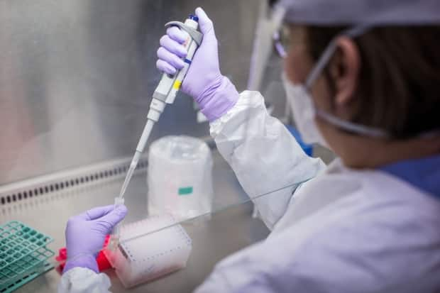 Lab techs are among the workers covered by the current contract negotiations. (Darryl Dyck/The Canadian Press - image credit)