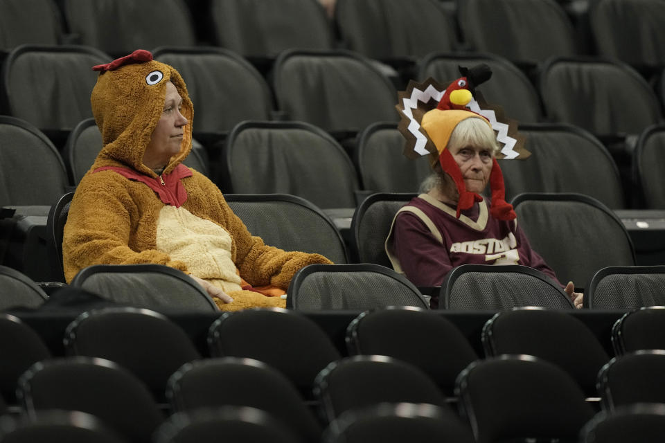 Boston College fans dressed in Thanksgiving costumes watchduring the first half of an NCAA college basketball game against Loyola Chicago Thursday, Nov. 23, 2023, in Kansas City, Mo. (AP Photo/Charlie Riedel)