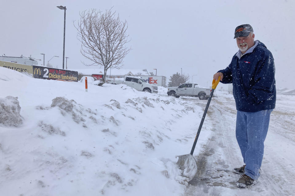 Dennis Fritsch, a trucker en route from Georgia to northern Nevada, stops at a truck stop in Bellemont, Arizona, on Thursday, Feb. 8, 2024, after parts of Interstate 40 shut down because of the weather. (AP Photo/Felicia Fonseca)