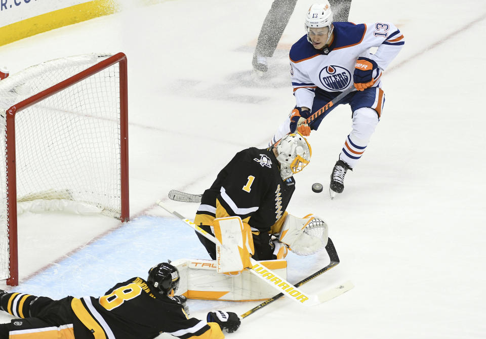 Pittsburgh Penguins goalie Casey DeSmith (1) makes a stop as Edmonton Oilers right wing Jesse Puljujarvi )133) applies pressure during the third period of an NHL hockey game, Thursday, Feb. 23, 2023, in Pittsburgh. The Oilers won 7-2. (AP Photo/Philip G. Pavely)