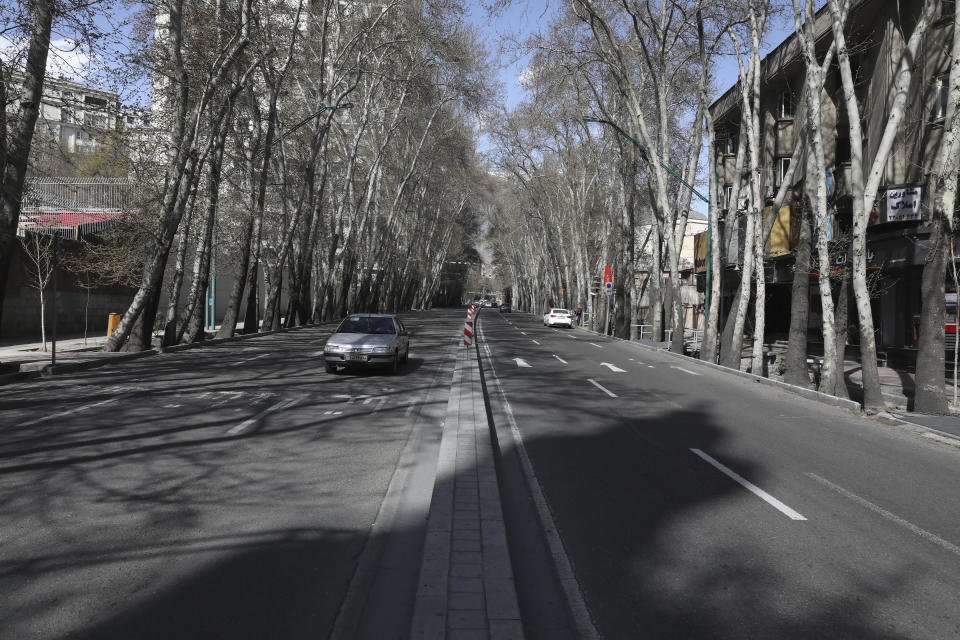 Cars drive in Vali-e-Asr St. which usually has congested traffic in northern Tehran, Iran, Friday, March 20, 2020, on the first day of Iranian New Year, called Nowruz, or "New Day" in Farsi, the Persian holiday marking the the spring equinox. The new coronavirus has cut into the ancient Nowruz and has further slowed the Islamic Republic's economy. (AP Photo/Vahid Salemi)