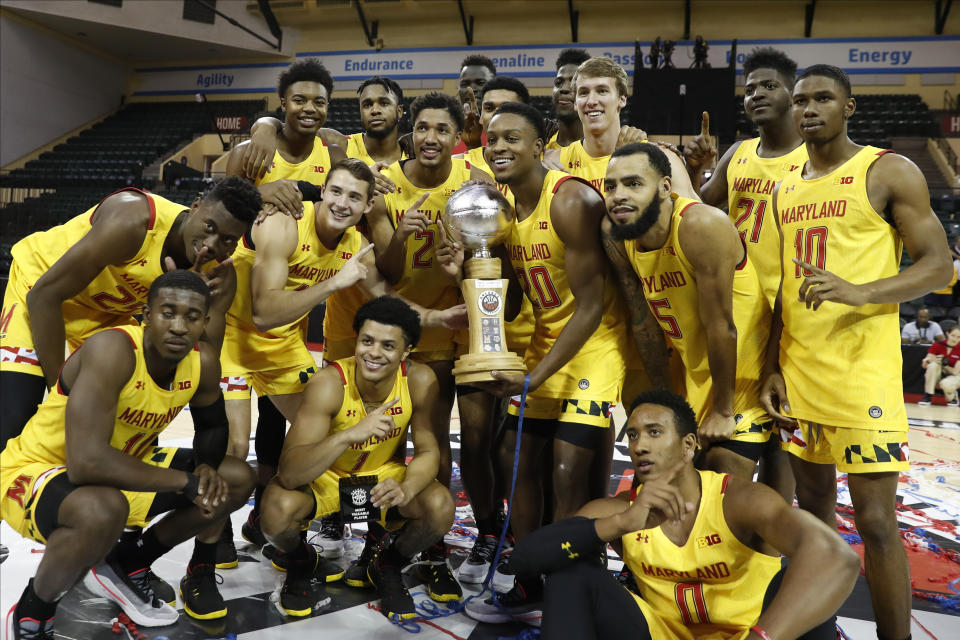 Maryland poses with the Orlando Invitational trophy after defeating Marquette during an NCAA college basketball game Sunday, Dec. 1, 2019, in Lake Buena Vista, Fla. (AP Photo/Scott Audette)