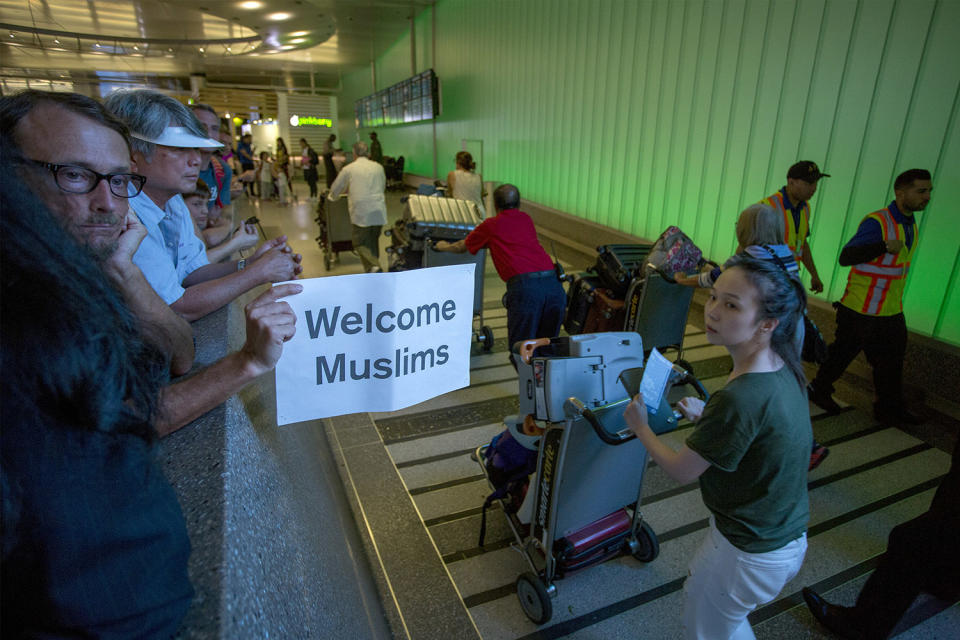 <p>John Wider carries a welcome sign near arriving international travelers on the first day of the the partial reinstatement of the Trump travel ban, temporarily barring travelers from six Muslim-majority nations from entering the U.S., at Los Angeles International Airport (LAX) on June 29, 2017 in Los Angeles, California. (David McNew/Getty Images) </p>