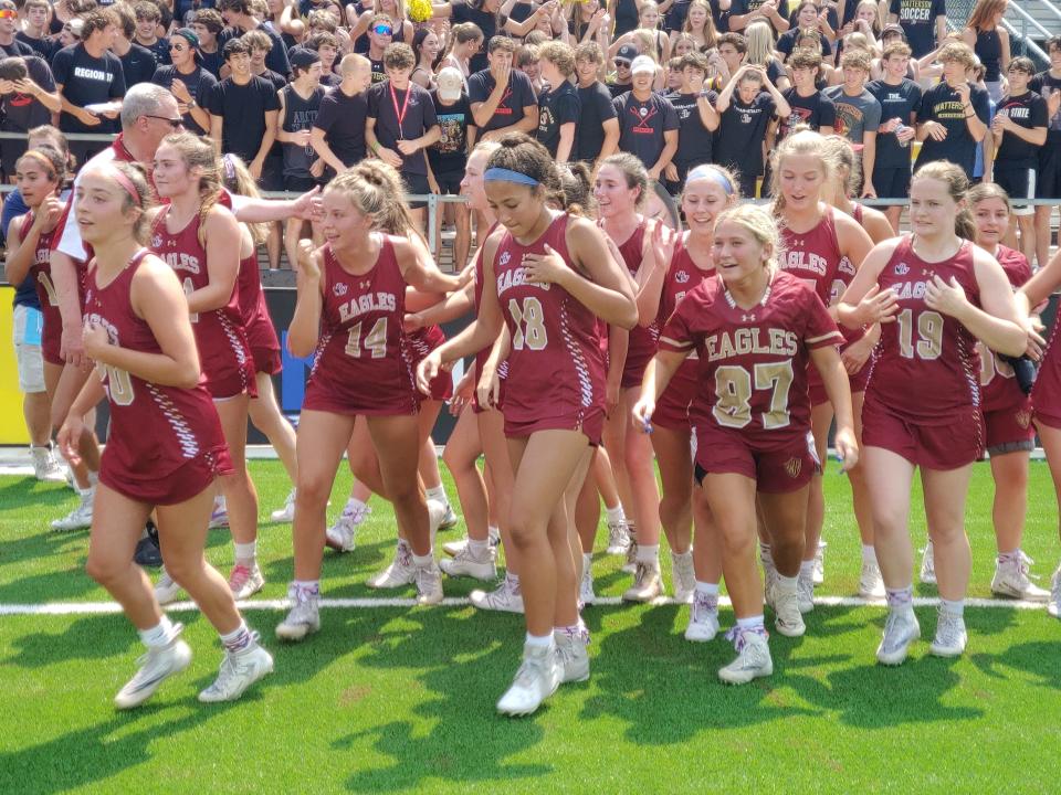 Watterson players head onto the field to receive their Division II state championship medals after defeating Shaker Heights Hathaway Brown 10-8 on Saturday at Historic Crew Stadium.