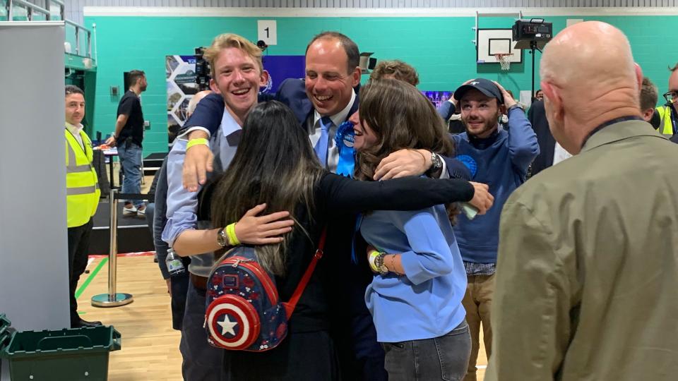 Greg Smith hugs three people at election count