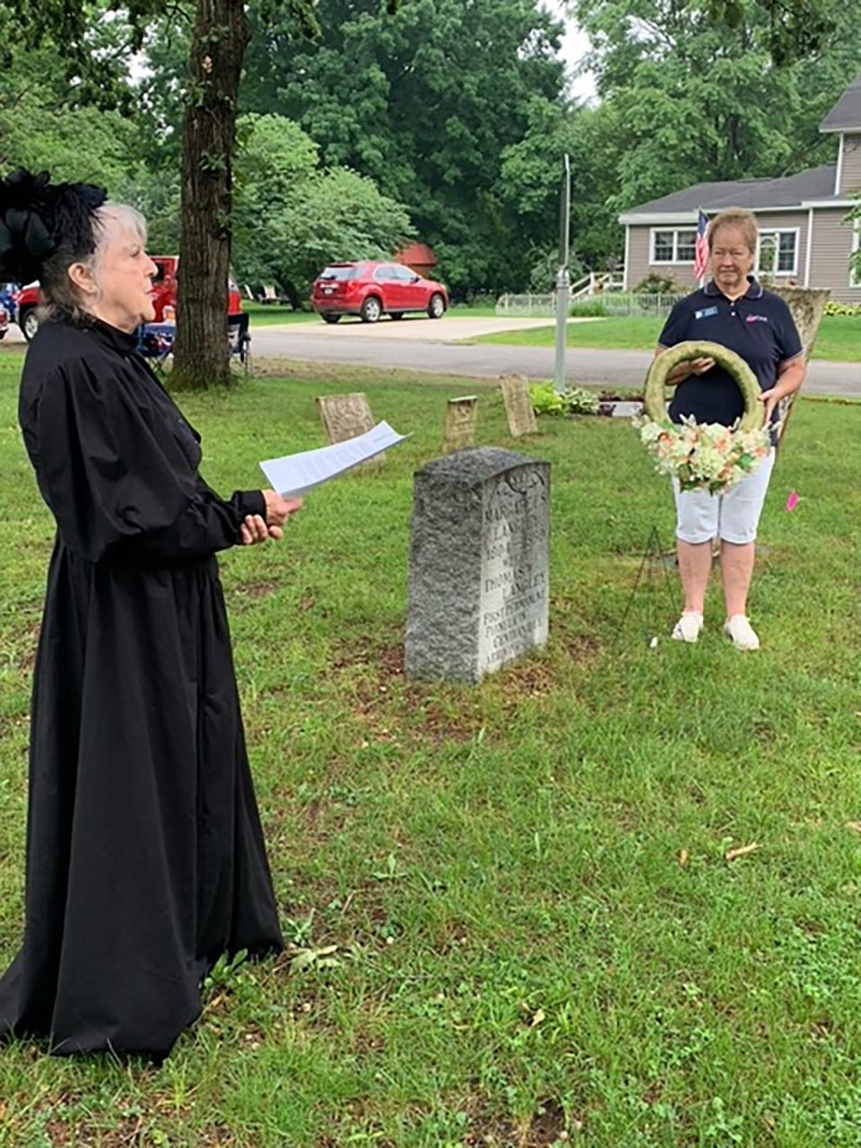 Liz Campbell and Jo Cherry, members of Amos Sturgis chapter of Daughters of the American Revolution, prepare to a lay a wreath at the gravesite of Centreville pioneer Margaret Langley during a ceremony at Old Centreville Cemetery.