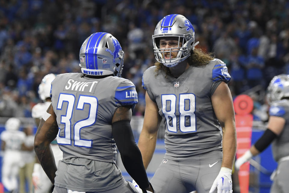 Detroit Lions running back D'Andre Swift (32) is greeted by tight end T.J. Hockenson (88) after scoring on a 7-yard run during the first half of an NFL football game against the Miami Dolphins, Sunday, Oct. 30, 2022, in Detroit. (AP Photo/Lon Horwedel)