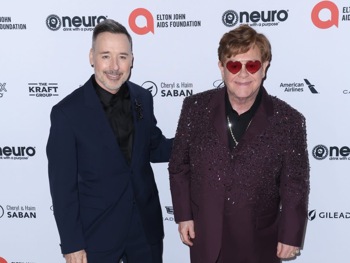 Elton John and husband David Furnish have condemned the home secretary (Getty)