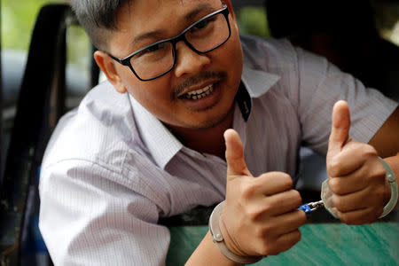 FILE PHOTO: Detained Reuters journalist Wa Lone gestures as he leaves after a court hearing in Yangon, Myanmar June 5, 2018. REUTERS/Ann Wang/File Photo