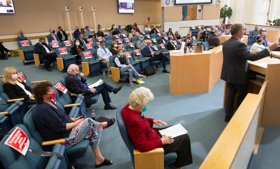 People listen to a discussion of the GL Homes of the proposed GL Homes land swap during a meeting before Palm Beach County Commissioners Wednesday, February 2, 2022.