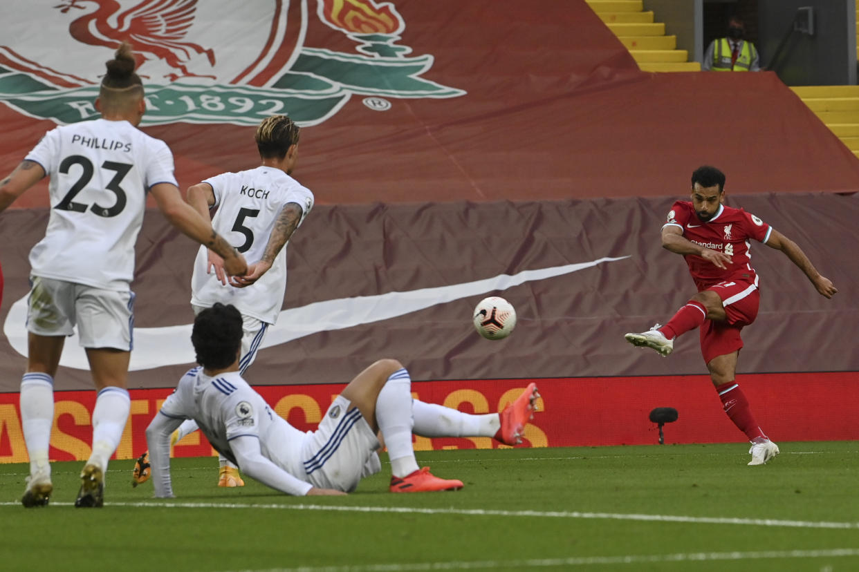 Liverpool's Mohamed Salah, right, scores his side's third goal during the English Premier League soccer match between Liverpool and Leeds United, at the Anfield stadium, in Liverpool, Saturday, Sept. 12, 2020. (Paul Ellis, Pool via AP)