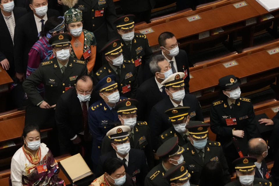 FILE - Chinese military officers leaves after the opening session of the annual meeting of China's National People's Congress (NPC) at the Great Hall of the People in Beijing on March 5, 2022. A conflict with China, which threatens to invade Taiwan, would be a disaster for all sides regardless of the outcome, Taiwan's defense minister said Thursday, March 10, 2022. (AP Photo/Sam McNeil, File)