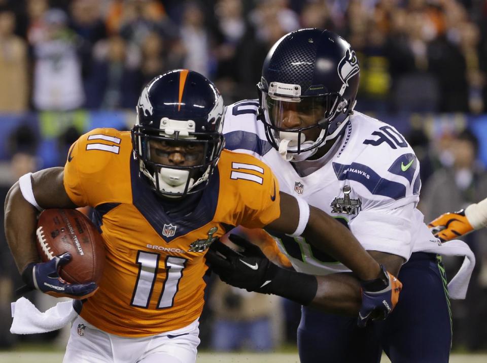 Denver Broncos' Trindon Holliday (11) runs from Seattle Seahawks' Derrick Coleman (40) during the first half of the NFL Super Bowl XLVIII football game Sunday, Feb. 2, 2014, in East Rutherford, N.J. (AP Photo/Matt Slocum)