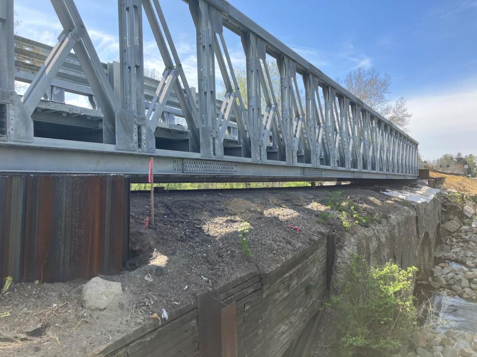 A new "Liberty Bridge" sits suspended above the crumbling Showman Arch Bridge, allowing the reopening of Charry Valley Road on April 27 after it had been closed since last October.