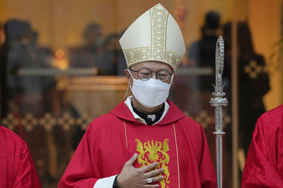 Stephen Chow wearing a surgical mask to protect against the coronavirus, poses after the episcopal ordination ceremony as the new Bishop of the Catholic Diocese, in Hong Kong, Saturday, Dec. 4, 2021. The new head of Hong Kong's Catholic diocese expressed hope Saturday that he could foster healing in a congregation and a city divided by the continuing fallout from massive anti-government protests in 2019. (AP Photo/Kin Cheung)