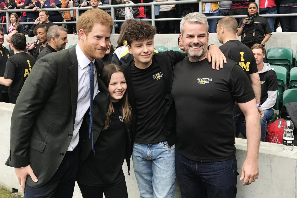 Comfort: Prince Harry with Emily Briggs, 11, Isaac Briggs, 13, and Matt Briggs at Twickenham: PA