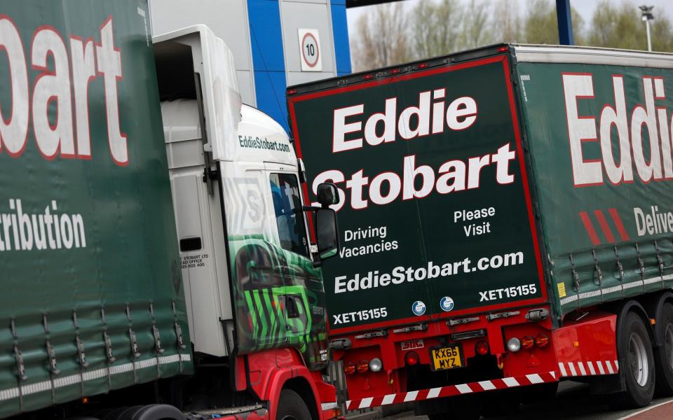 Eddie Stobart lorries queue at a security barrier