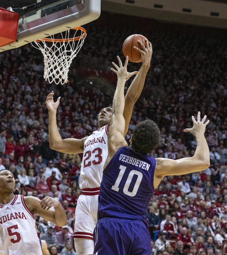 Indiana forward Trayce Jackson-Davis (23) grabs a rebound against Northwestern forward Tydus Verhoeven (10) during the first half an NCAA college basketball game, Sunday, Jan. 8, 2023, in Bloomington, Ind. (AP Photo/Doug McSchooler)