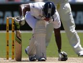 England's Michael Carberry leans on his bat after he misses a shot during the third day of the second Ashes test cricket match against Australia at the Adelaide Oval December 7, 2013.