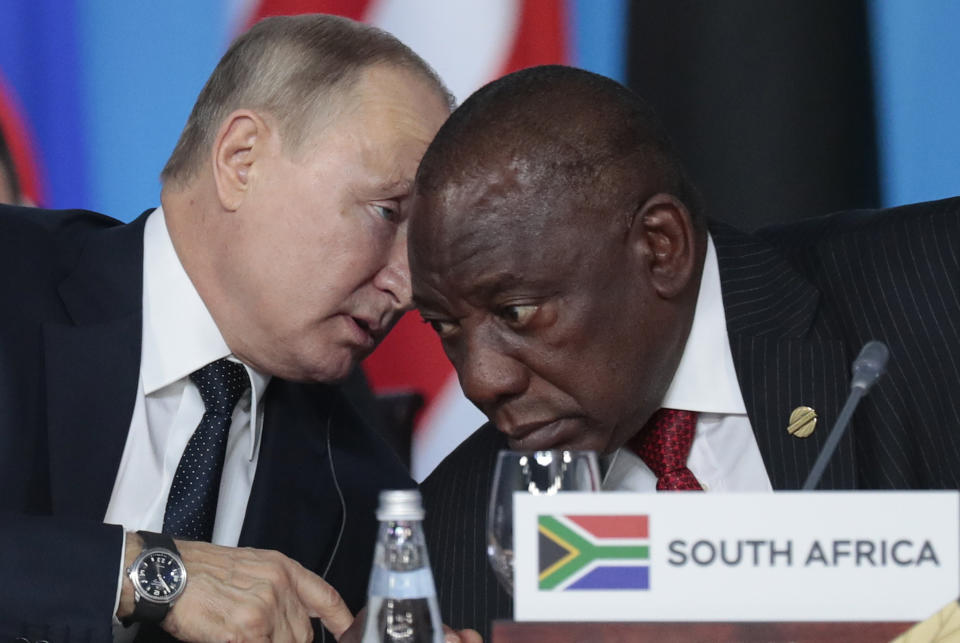 FILE - Russian President Vladimir Putin, left, speaks to South African President, Cyril Ramaphosa, right, during a plenary session at the Russia-Africa summit in the Black Sea resort of Sochi, Russia on Oct. 24, 2019. A bipartisan group of U.S. lawmakers wants the Biden Administration to punish South Africa for what they call its support for Russia's illegal invasion of Ukraine by relocating this year's AGOA America-Africa trade meeting to another country. (Sergei Chirikov/Pool Photo via AP, File)