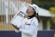 Jin Young Ko of South Korea kisses the winner's trophy after winning the BMW Ladies Championship at LPGA International Busan in Busan, South Korea, Sunday, Oct. 24, 2021. (AP Photo/Lee Jin-man)