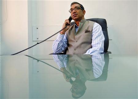 Editor in Chief and CEO of Dainik Jagran newspaper Sanjay Sharma speaks on a telephone inside his office in New Delhi March 3, 2014. REUTERS/Anindito Mukherjee