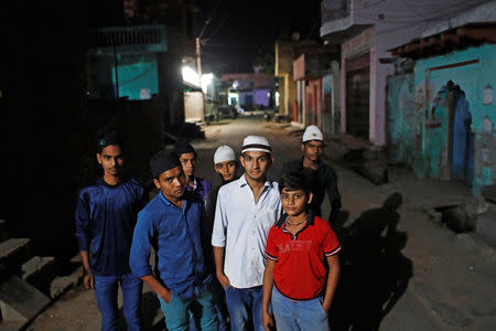 Mulsim children stand outside a mosque as they arrive to offer their morning prayer during the holy month of Ramadan in village Nayabans in the northern state of Uttar Pradesh, India May 10, 2019. Picture taken on May 10, 2019. REUTERS/Adnan Abidi