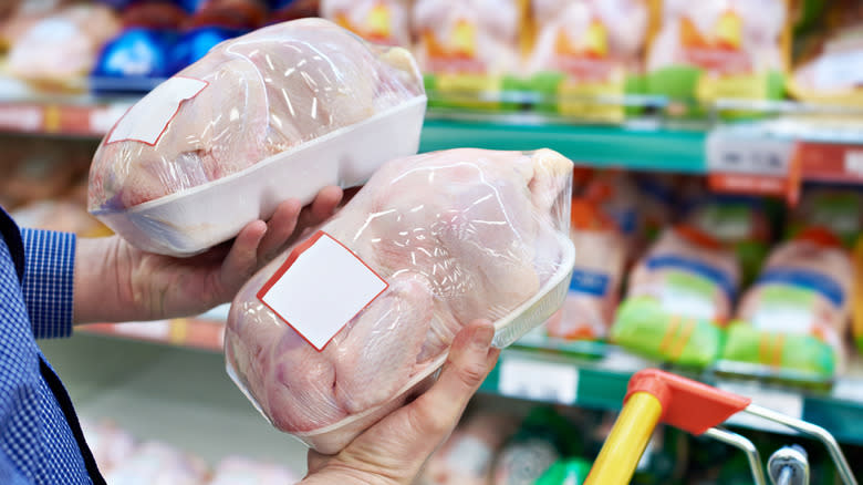 Person looking at packages of chicken