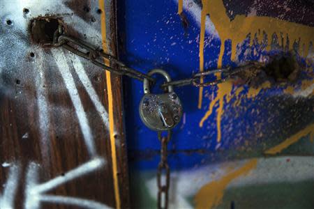 A padlock secures the wooden cabin of Dimitar "Mitko" Todorov, a Roma from the Bulgarian city of Plevna, in a derelict factory in Berlin, December 5, 2013. REUTERS/Thomas Peter