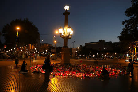 People gather at an impromptu memorial where a van crashed into pedestrians at Las Ramblas in Barcelona, Spain August 21, 2017. REUTERS/Susana Vera