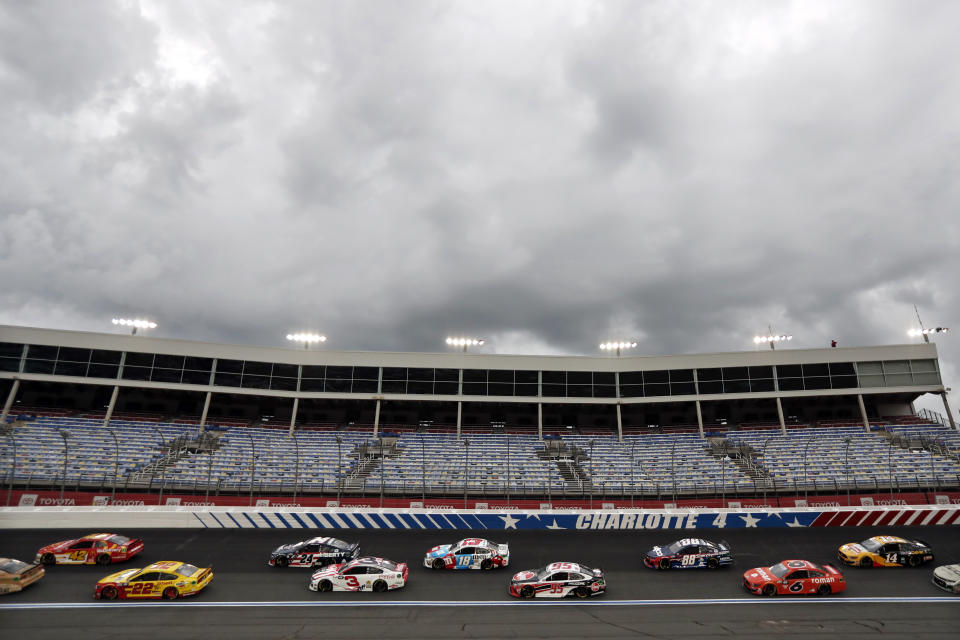 Dark clouds fill the sky during the NASCAR Cup Series auto race at Charlotte Motor Speedway Sunday, May 24, 2020, in Concord, N.C. (AP Photo/Gerry Broome)