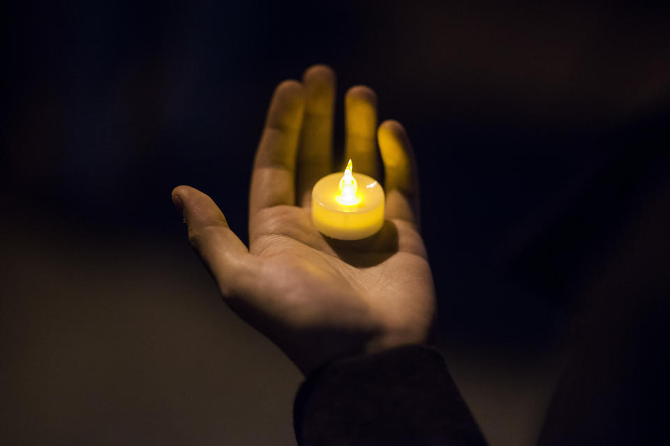 <p>A man holds a candle during an interfaith vigil for peace in response to Manhattan Attack at Foley square, Wednesday, Nov. 1, 2017, in New York. (AP Photo/Andres Kudacki) </p>