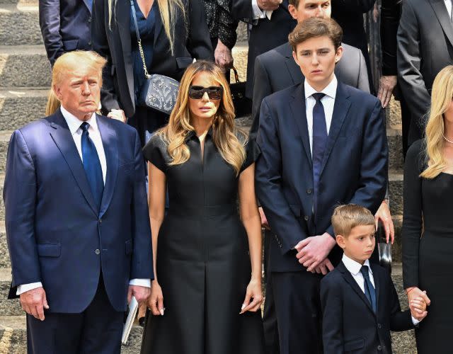NEW YORK, NEW YORK – JULY 20: Former U.S. President Donald Trump, former U.S. First Lady Melania Trump and Barron Trump are seen at the funeral of <span class="caas-xray-inline-tooltip"><span class="caas-xray-inline caas-xray-entity caas-xray-pill rapid-nonanchor-lt" data-entity-id="Ivana_Trump" data-ylk="cid:Ivana_Trump;pos:6;elmt:wiki;sec:pill-inline-entity;elm:pill-inline-text;itc:1;cat:BusinessPerson;" tabindex="0" aria-haspopup="dialog"><a href="https://search.yahoo.com/search?p=Ivana%20Trump" data-i13n="cid:Ivana_Trump;pos:6;elmt:wiki;sec:pill-inline-entity;elm:pill-inline-text;itc:1;cat:BusinessPerson;" tabindex="-1" data-ylk="slk:Ivana Trump;cid:Ivana_Trump;pos:6;elmt:wiki;sec:pill-inline-entity;elm:pill-inline-text;itc:1;cat:BusinessPerson;" class="link ">Ivana Trump</a></span></span> on July 20, 2022 in New York City. (Photo by James Devaney/GC Images)