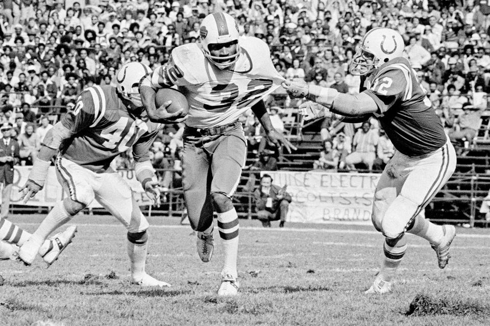 FILE - Buffalo Bills running back O.J. Simpson (32) has his jersey pulled by Baltimore Colts linebacker Mike Curtis, during the second quarter of an NFL football game in Baltimore, Md., Oct. 12, 1975. Simpson's attorney Malcolm LaVergne is now handling the deceased former football star, actor and famous murder defendant's financial estate. (AP Photo/File)