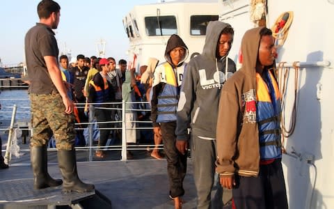 African migrants, who according to the Libyan navy were rescued by the country's coast guard, arrive at the naval base of the capital Tripoli on July 12 - Credit: AFP