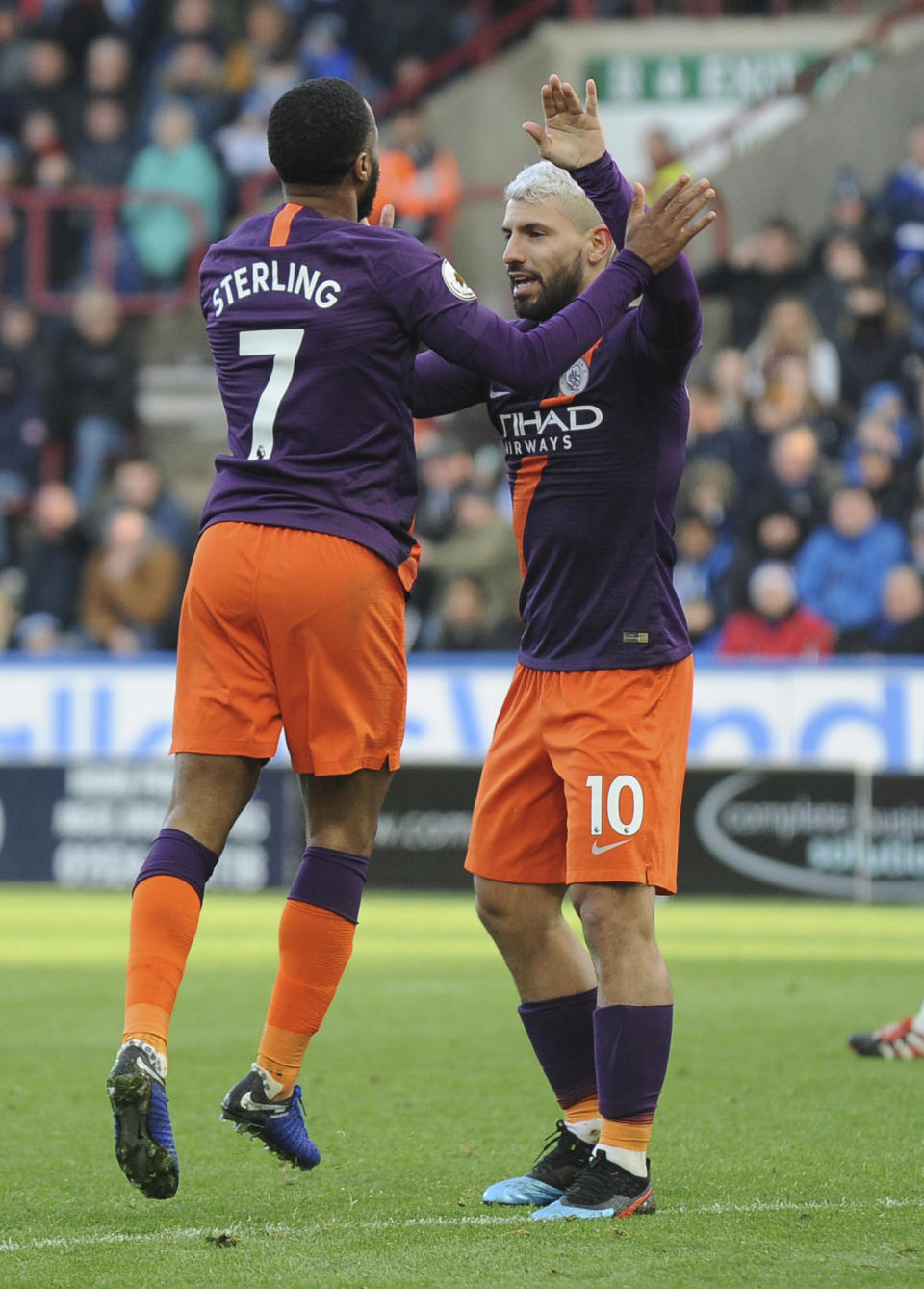 Manchester City's Raheem Sterling, left, celebrates teammate Sergio Aguero, after scoring the second goal for his team, during the English Premier League soccer match between Huddersfield Town and Manchester City at John Smith's stadium in Huddersfield, England, Sunday, Jan. 20, 2019. (AP Photo/Rui Vieira)