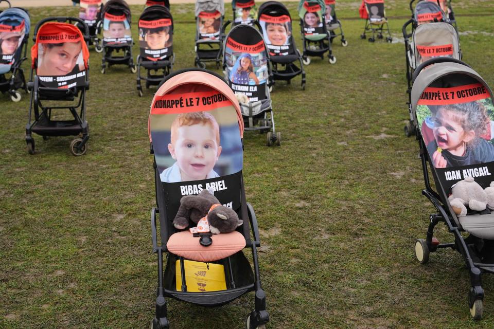 Baby strollers with images of young Israeli children taken hostage by Hamas are shown during a demonstration calling for their release in Paris on Oct. 26, 2023. <a href="https://www.gettyimages.com/detail/news-photo/baby-strollers-with-images-of-young-hostages-bibas-ariel-news-photo/1745589782?adppopup=true" rel="nofollow noopener" target="_blank" data-ylk="slk:Dimitar Dilkoff/AFP via Getty Images;elm:context_link;itc:0;sec:content-canvas" class="link ">Dimitar Dilkoff/AFP via Getty Images</a>