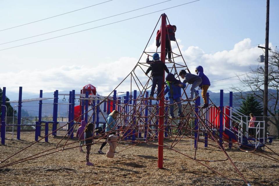 Children play at the Silver Beach Elementary School playground Friday, April 14, 2023, in Bellingham, Wash. The playground is expected to be replaced with an inclusive playground by the 2023-2024 school year. Rachel Showalter/The Bellingham Herald