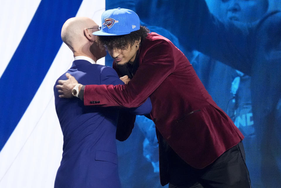 Dereck Lively II greets NBA Commissioner Adam Silver after being selected 12th overall by the Oklahoma City Thunder during the NBA basketball draft, Thursday, June 22, 2023, in New York. (AP Photo/John Minchillo)